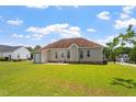 This home features a spacious backyard with a well-maintained lawn, mature trees and exterior rear entrance at 1325 Sweetclover Dr, Wake Forest, NC 27587