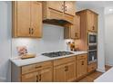 Well-equipped kitchen with a gas range, built-in microwave and oven, and ample counter space at 134 Beacon Dr, Pittsboro, NC 27312