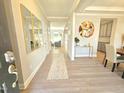 Bright foyer with stylish decor, featuring a console table, modern art, and a view into the adjoining dining area at 1412 Queen Trigger Dr, Fuquay Varina, NC 27526