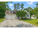 Charming home featuring a spacious driveway, two-car garage, manicured lawn, and inviting curb appeal at 153 Hickory Nut Dr, Smithfield, NC 27577