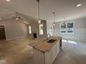 Open-concept kitchen with island, pendant lighting, and view of living room at 165 Tee Dr, Selma, NC 27576