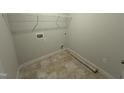 The laundry room features tiled floors, washer and dryer hookups, and overhead storage at 165 Tee Dr, Selma, NC 27576