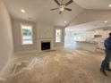 Spacious living room with vaulted ceiling, fireplace, and views of kitchen at 165 Tee Dr, Selma, NC 27576
