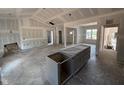 Unfinished kitchen with an island and cabinets ready for customization at 183 Tee Dr, Selma, NC 27576