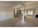 An unfinished living room featuring recessed lights, fireplace, wainscotting, with access to kitchen and outdoor patio at 183 Tee Dr, Selma, NC 27576