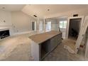 An unfinished living room featuring recessed lights, fireplace, with access to kitchen at 183 Tee Dr, Selma, NC 27576