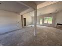 Spacious living room with soaring ceilings, large windows, and modern design elements, ready to be finished at 183 Tee Dr, Selma, NC 27576
