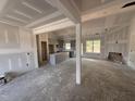 Spacious living room under construction with an open floor plan and views into the kitchen at 183 Tee Dr, Selma, NC 27576
