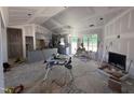 Bright living room showcasing new drywall, a fireplace, and large windows at 183 Tee Dr, Selma, NC 27576