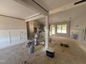 Spacious living room boasts board and batten wainscoting, a fireplace, and an open floor plan leading to the kitchen at 183 Tee Dr, Selma, NC 27576