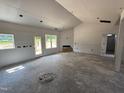 Bright and airy living room with large windows, open floor plan, and potential for cozy gatherings at 183 Tee Dr, Selma, NC 27576
