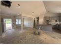 An unfinished living room featuring recessed lights, wainscotting, with access to kitchen and outdoor patio at 183 Tee Dr, Selma, NC 27576