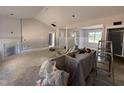 Partially finished living room featuring a fireplace, an open concept design, and primed walls ready for paint at 183 Tee Dr, Selma, NC 27576