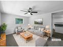 Bright, staged living room featuring a ceiling fan, neutral color scheme, and comfortable seating at 1914 Adams Pl, Hillsborough, NC 27278