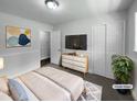 Bedroom features neutral walls, a dresser with a TV, and closet for ample storage at 1914 Adams Pl, Hillsborough, NC 27278
