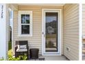 Cozy front porch with a wicker chair, side table and window at 2128 Jollay St, Durham, NC 27703