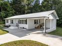 Side view of this charming white-brick home showing a carport and nice lawn at 2210 Pilot-Riley Rd, Zebulon, NC 27597