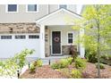 Inviting front porch with stone accents and a landscaped garden, perfect for relaxing outdoors at 2264 Jollay St, Durham, NC 27703