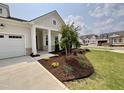 Landscaped front of new home with large driveway at 2400 Abbeyhill Dr # 36, Raleigh, NC 27610