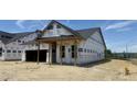 New home construction shows Tyvek wrap and framing with the new roof and covered porch at 2400 Fleming Stone Ln # 52, Raleigh, NC 27610
