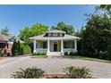 Beautiful single-story home with a charming front porch, green shutters, and landscaped front yard at 308 W Whitaker Mill Rd, Raleigh, NC 27608
