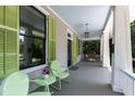 Charming porch seating with a light blue ceiling, green shutters, and white pillars at 308 W Whitaker Mill Rd, Raleigh, NC 27608