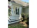 A covered back porch with steps and white pillars for a peaceful outdoor area at 3298 Oakridge Dr # A, Graham, NC 27253