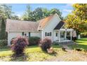 Inviting single-story home with lush front yard landscaping and a cozy covered porch at 3298 Oakridge Dr # A, Graham, NC 27253
