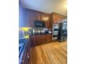 This kitchen boasts wooden cabinets, hardwood floors, and stainless steel appliances at 3298 Oakridge Dr # A, Graham, NC 27253