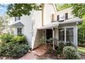 Charming home exterior with manicured landscaping, brick walkway, and neutral siding at 352 Weymouth Close, Pittsboro, NC 27312