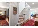 Bright foyer featuring hardwood floors, staircase, and decorative accents at 352 Weymouth Close, Pittsboro, NC 27312