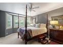 Comfortable main bedroom with a four-poster bed, bay windows, and plush carpeting at 352 Weymouth Close, Pittsboro, NC 27312