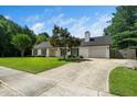 Classic home with manicured lawn, mature landscaping, and a welcoming driveway at 401 Wyndham Drive, Fuquay Varina, NC 27526