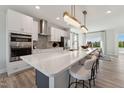 Contemporary kitchen with a spacious island, white countertops, and stainless steel appliances at 404 Gaston Park Ln # 200, Wake Forest, NC 27587