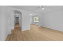 Bright living room with light wood flooring and arched doorways at 413 Top Greene Ln, Raleigh, NC 27601