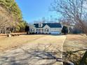 View of a charming one-story home with well-kept lawn and a long private driveway at 414 Ash Lily Ct, Nashville, NC 27856