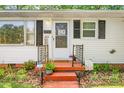Close-up of the inviting front porch with decorative elements and plants at 422 Hyde St, Burlington, NC 27217