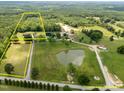 Aerial view showing property lines, pond, and vast acreage of wooded land at 4659 Antioch Rd, Oxford, NC 27565