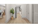 Bright hallway leads to an open-concept kitchen with modern appliances and seamless flow throughout the home at 516 Ottawa Ave, Durham, NC 27701