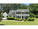 Charming two-story home with a landscaped lawn, dormer windows, and black shutters at 5301 Night Heron Dr, Wake Forest, NC 27587