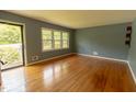 Sun-lit living room boasting hardwood floors and a large window at 5504 Balsam Pl, Raleigh, NC 27603