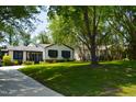 Landscaped yard surrounds this charming home with beautiful lawn and mature trees at 5617 Groomsbridge Ct, Raleigh, NC 27612