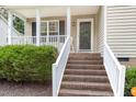 Inviting front porch with brick steps and white railing at 5817 Seward Dr, Knightdale, NC 27545