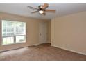 Bright living room with carpet, ceiling fan and large window providing natural light at 5949 Sandy Run, Knightdale, NC 27545