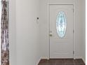Bright foyer featuring a decorative glass front door and tile flooring at 6411 Pondview Ln, Durham, NC 27712