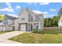 Charming two-story home with light grey siding, brick accents, and a well-manicured lawn at 6512 Bunker Hill Dr, Raleigh, NC 27610