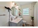 Clean bathroom with a modern vanity, updated fixtures, a round mirror and a walk-in shower at 7 Woodward Way, Chapel Hill, NC 27516