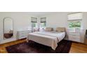 Well-lit bedroom with hardwood floors, a large bed, a walk-in closet and ample storage space at 7 Woodward Way, Chapel Hill, NC 27516