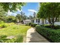 Beautifully landscaped yard with green grass, flowerbeds and manicured bushes at 877 Millcroft, Pittsboro, NC 27312