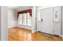 Inviting foyer featuring hardwood floors and elegant wainscoting at 1084 Wild Briar Ln, Stem, NC 27581